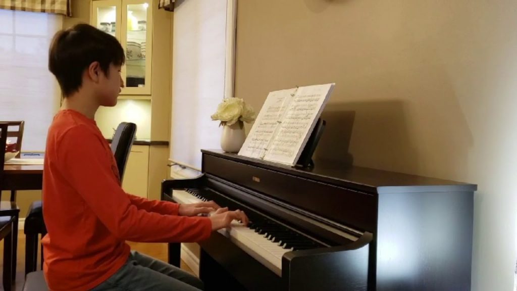 A person standing in front of a piano
