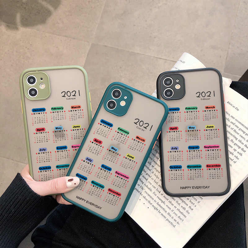 A person holding three phones on a book