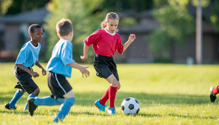 A group of kids playing a game of football